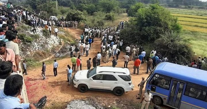 Policemen and public at the spot where all the four accused in the vet rape and murder case was shot dead at Chatanpally, near Hyderabad, early Friday.