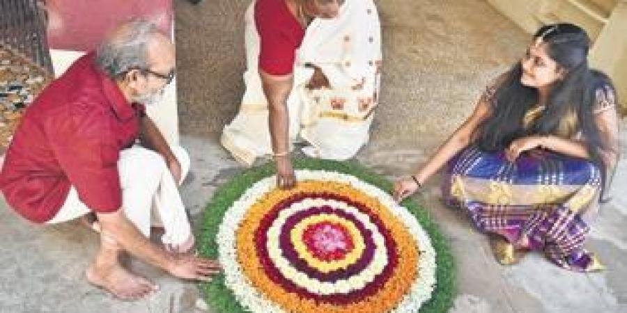 A family drawing pookolam on the eve of Onam at Annanur