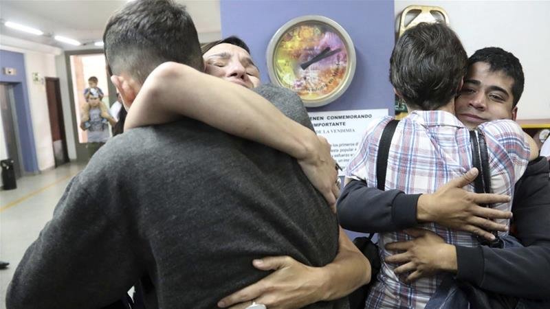 Victims and relatives from the Antonio Provolo Institute for Deaf and Hearing Impaired Children embrace after hearing a guilty verdict for their abusers.