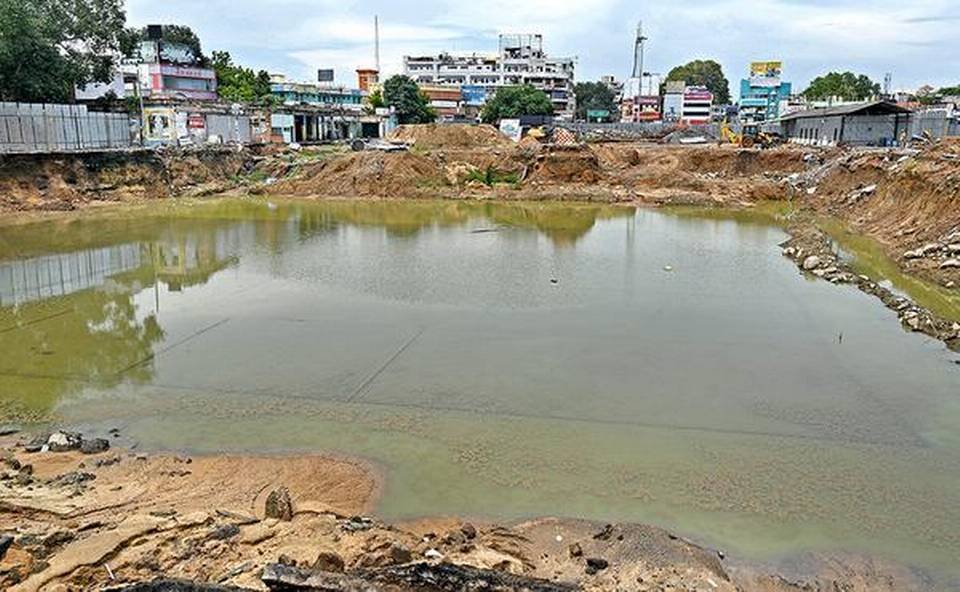 Rainwater stagnating at Periyar bus stand in Tirunelveli junction where construction work is going on for new buildings.