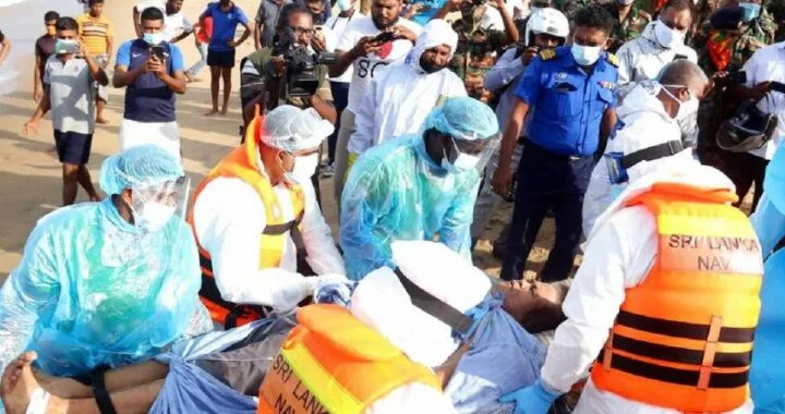 An injured crew member of the MT New Diamond, is transferred on stretcher to an ambulance Thursday, Sept. 3, 2020, in Sangamankanda, Sri Lanka.