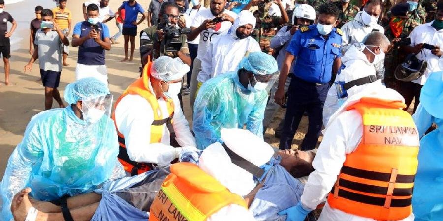 An injured crew member of the MT New Diamond, is transferred on stretcher to an ambulance Thursday, Sept. 3, 2020, in Sangamankanda, Sri Lanka.